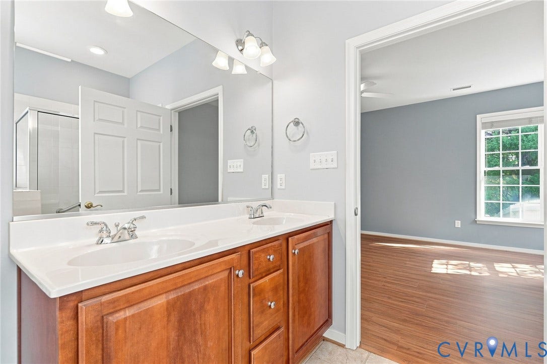 Double vanity with integrated sinks and chrome fixtures