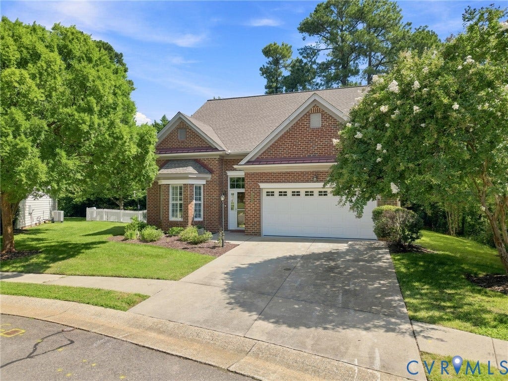 Brick exterior with bay window and attached garage
