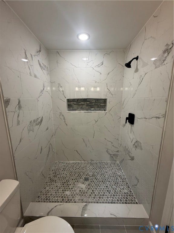 3430 The Loop Rd, Glendale, Montross, VA 23231 Shower enclosure featuring white marbled tile, a decorative mosaic-tiled niche, a hexagonal mosaic tile floor, and matte black fixtures