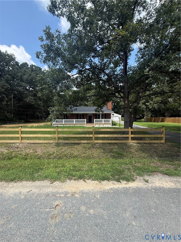 3430 The Loop Rd, Glendale, Montross, VA 23231 Red brick exterior with white trim, covered front porch, white porch railing, and a wood split-rail fence