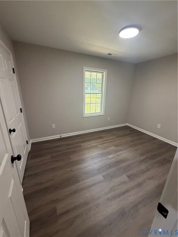 3430 The Loop Rd, Glendale, Montross, VA 23231 Wood-finish flooring, white trim, and a ceiling-mounted light fixture