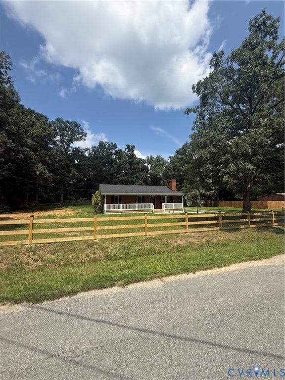 3430 The Loop Rd, Glendale, Montross, VA 23231 Single-story residence with a covered front porch and white railings, featuring a red brick chimney