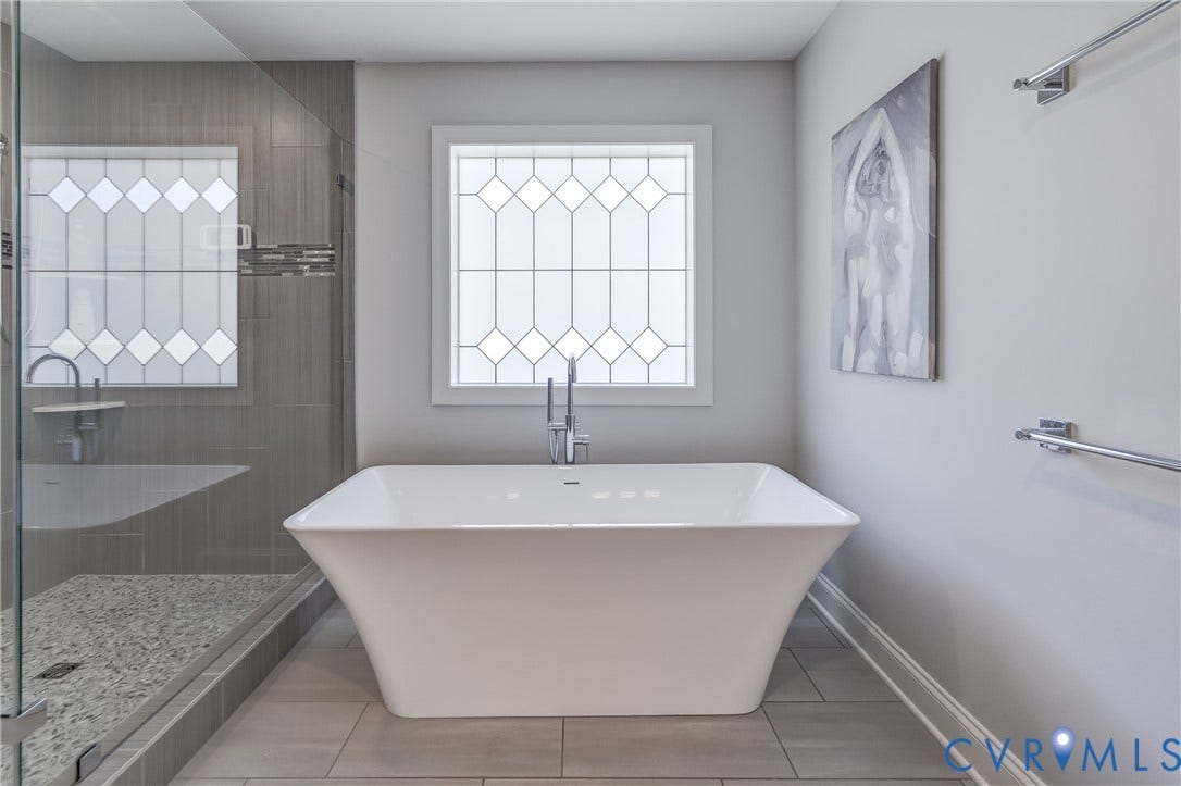11515 Grey Oaks Estates Run, Grey Oaks Estates, Glen Allen, VA 23059 Freestanding soaking tub with chrome fixtures, glass-enclosed shower with pebble floor, gray tile shower surround, and decorative privacy windows