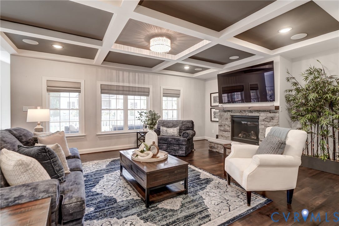 11515 Grey Oaks Estates Run, Grey Oaks Estates, Glen Allen, VA 23059 Coffered ceiling with recessed smart lighting and central chandelier, stone fireplace with a wood mantle, and dark wood-finish flooring