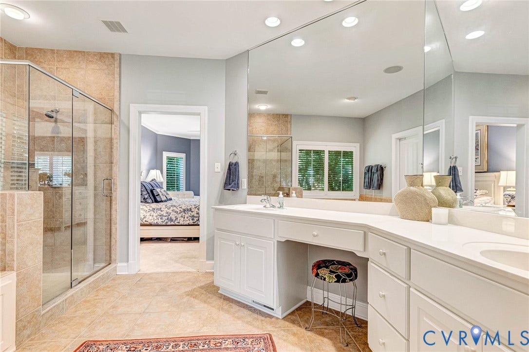 Glass-enclosed shower with tile surround