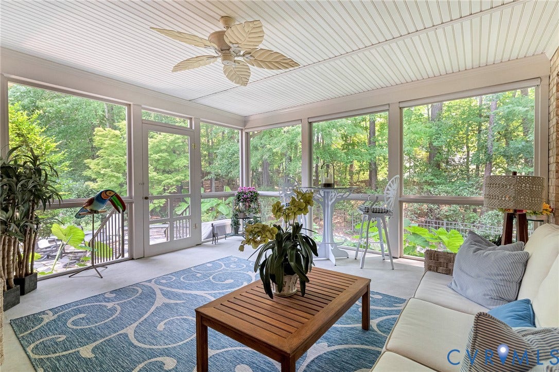 Screened-in porch with ceiling fan and direct outdoor access