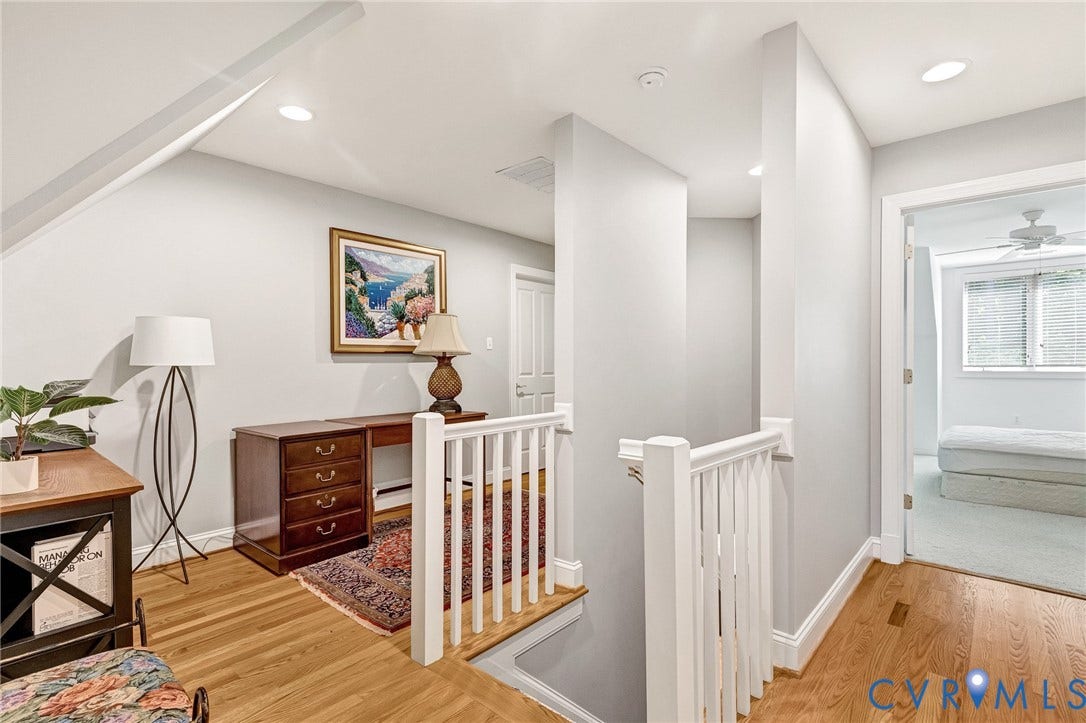 Hardwood flooring, white painted railings, recessed lighting, attic ceiling line, and a bright interior paint palette