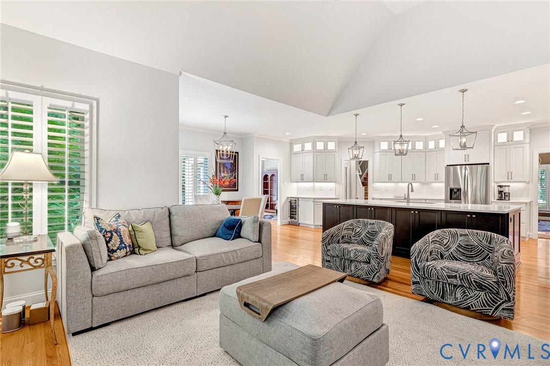 Vaulted ceilings, plantation shutters, hardwood flooring, stainless steel appliances, and a large kitchen island