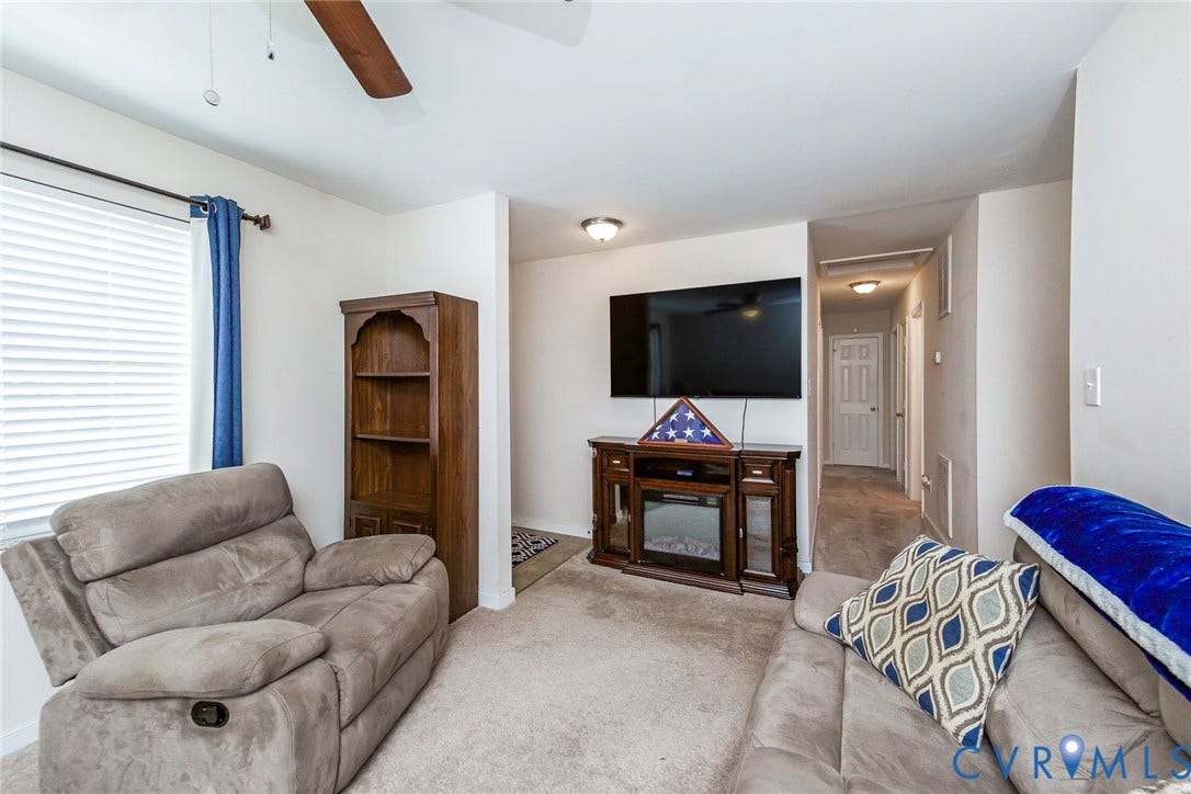 2765 Meadowbrook Street, Petersburg, VA 23803 Carpeted living space with a ceiling fan, window with blinds, and built-in media console