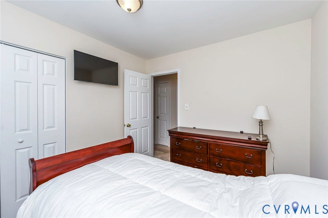2765 Meadowbrook Street, Petersburg, VA 23803 White bi-fold closet doors and a flush-mount ceiling light fixture