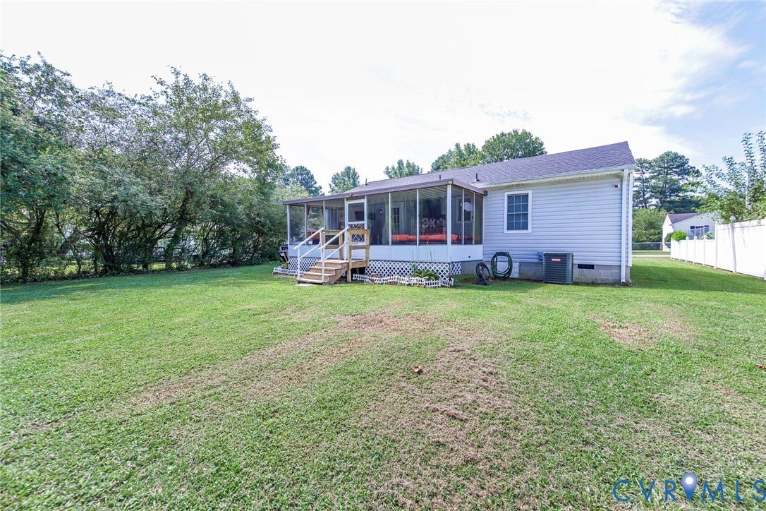 2765 Meadowbrook Street, Petersburg, VA 23803 Spacious rear yard with a screened porch, wood-finish deck, and white privacy fencing