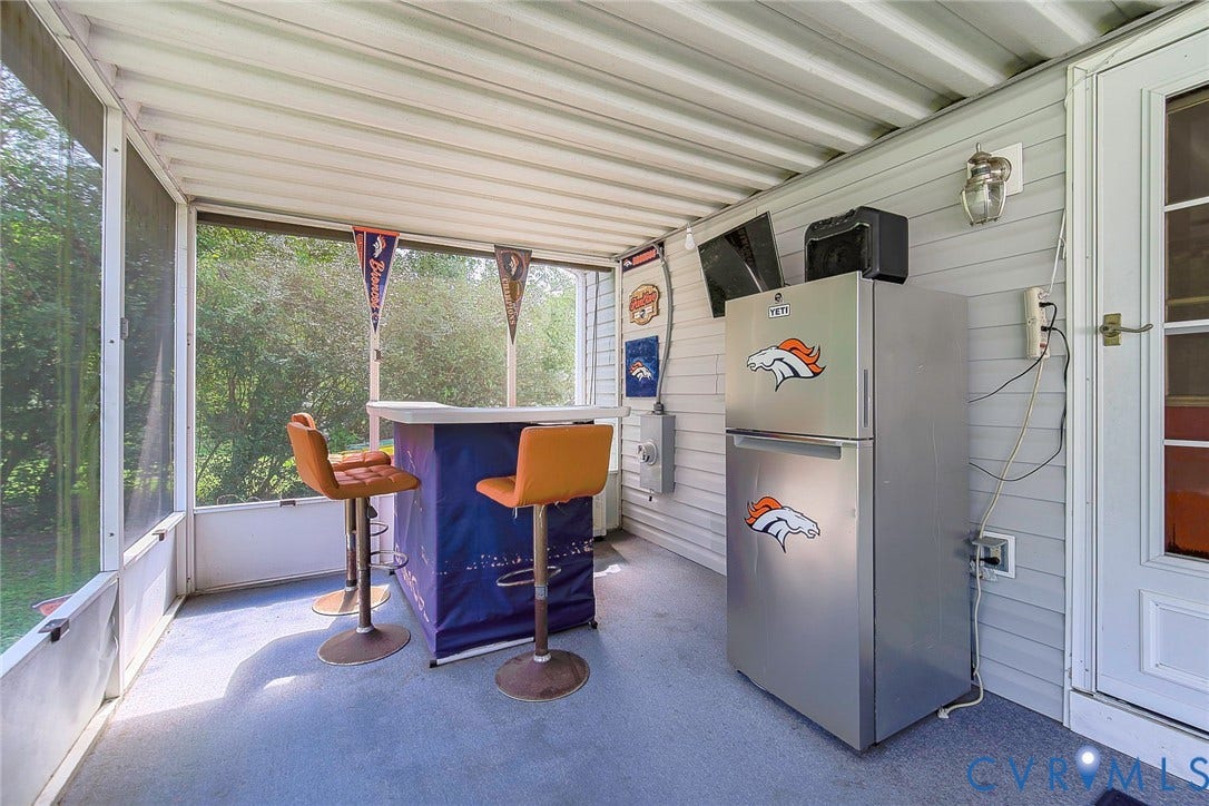 2765 Meadowbrook Street, Petersburg, VA 23803 Screened-in porch featuring a textured ceiling, exterior siding, and an access door with glass panels