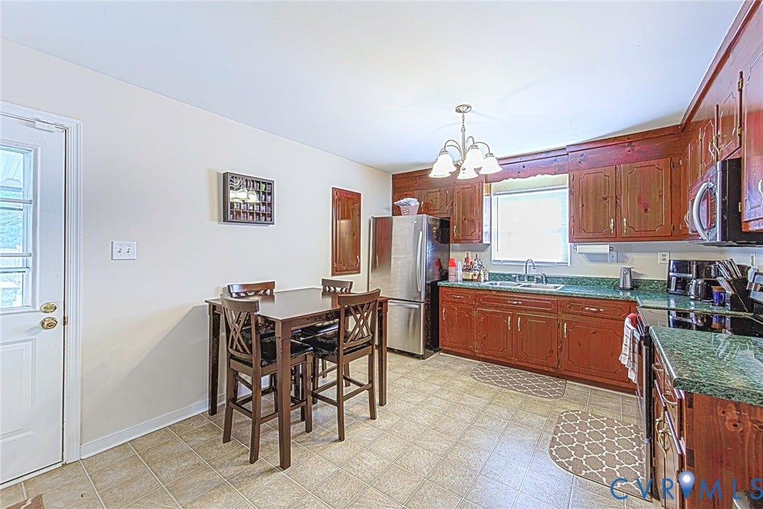 2765 Meadowbrook Street, Petersburg, VA 23803 Kitchen featuring wood-finish cabinetry, green countertops, stainless steel appliances, and a tiled floor