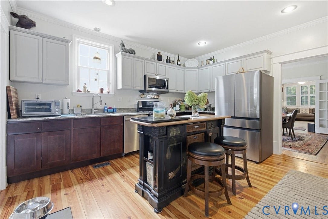 4702 New Kent Avenue, Westover Hills, Richmond, VA 23225 Kitchen featuring wood-finish flooring, two-tone cabinetry, stainless steel appliances, a center island with seating, and recessed lighting
