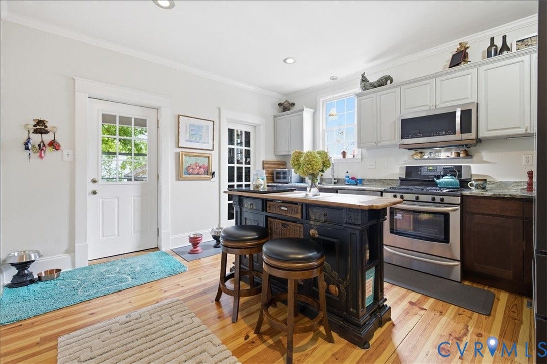4702 New Kent Avenue, Westover Hills, Richmond, VA 23225 Kitchen featuring wood-finish flooring, recessed lighting, and a dark-toned island with seating granite counters