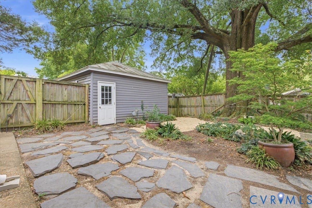 4702 New Kent Avenue, Westover Hills, Richmond, VA 23225 Flagstone patio with an expansive wooden privacy fence and a detached storage building on lovely treed lot.