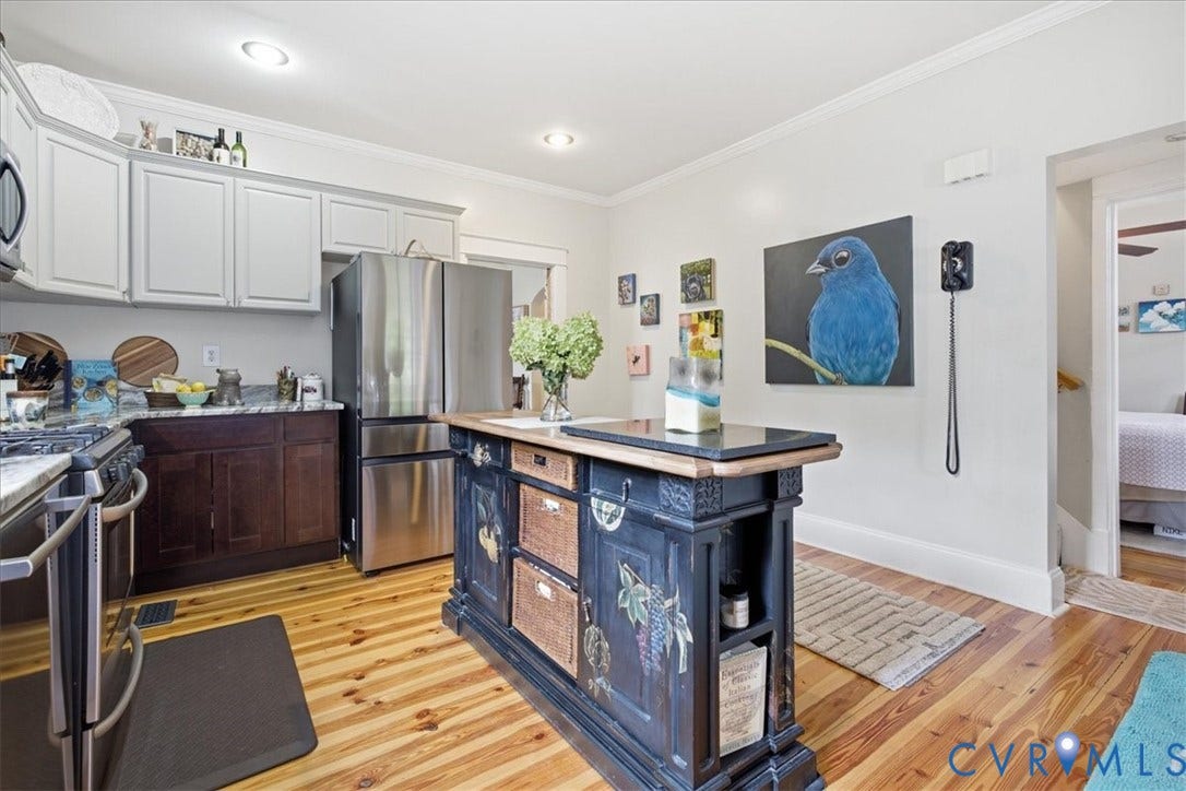 4702 New Kent Avenue, Westover Hills, Richmond, VA 23225 Kitchen featuring wood-finish flooring, two-tone cabinetry, stainless steel appliances, granite countertops, and a decorative island with a contrasting stone top