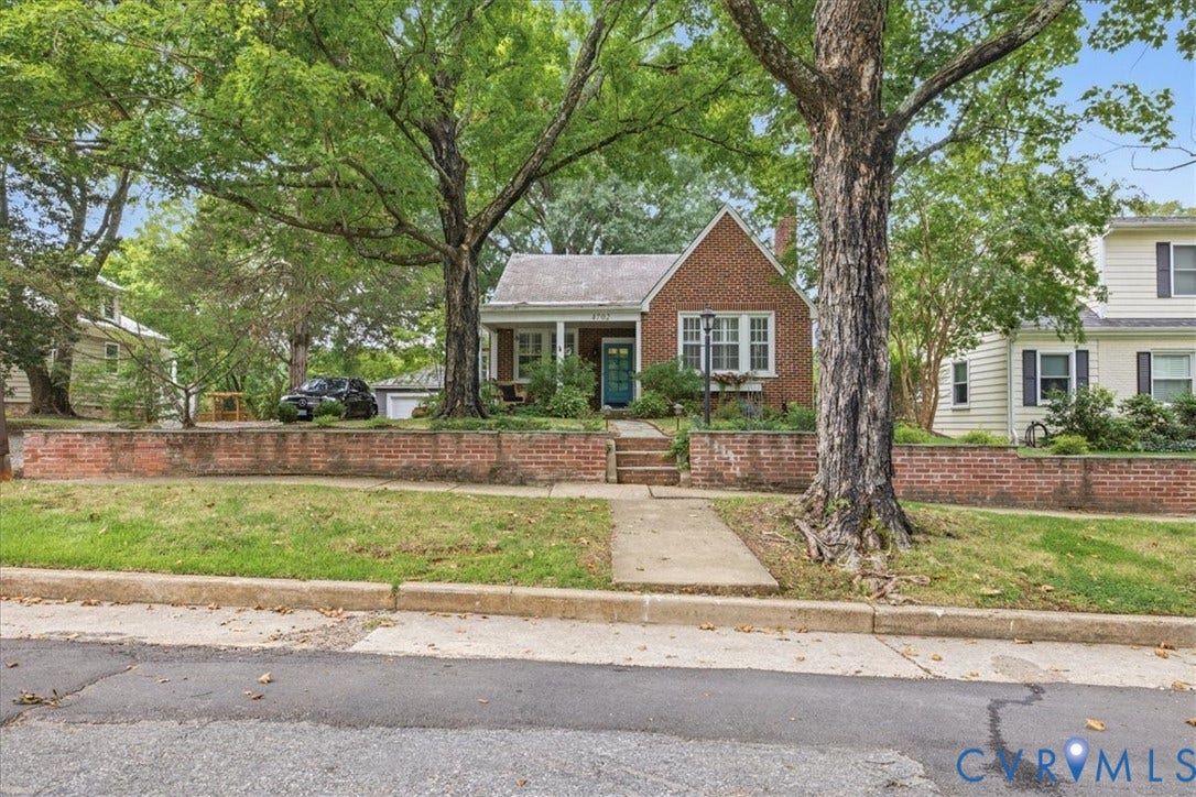 4702 New Kent Avenue, Westover Hills, Richmond, VA 23225 Brick exterior with white window trim, a covered front porch, and mature trees in the front yard
