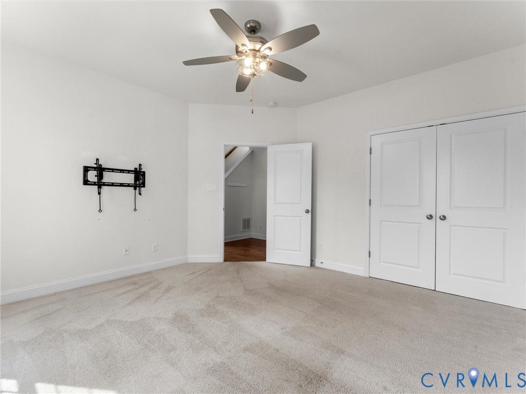 14227 Michaux Village Drive, Winterfield Park, Midlothian, VA 23113 Neutral-toned carpet flooring, a ceiling fan with integrated lighting, and white walls create a bright interior