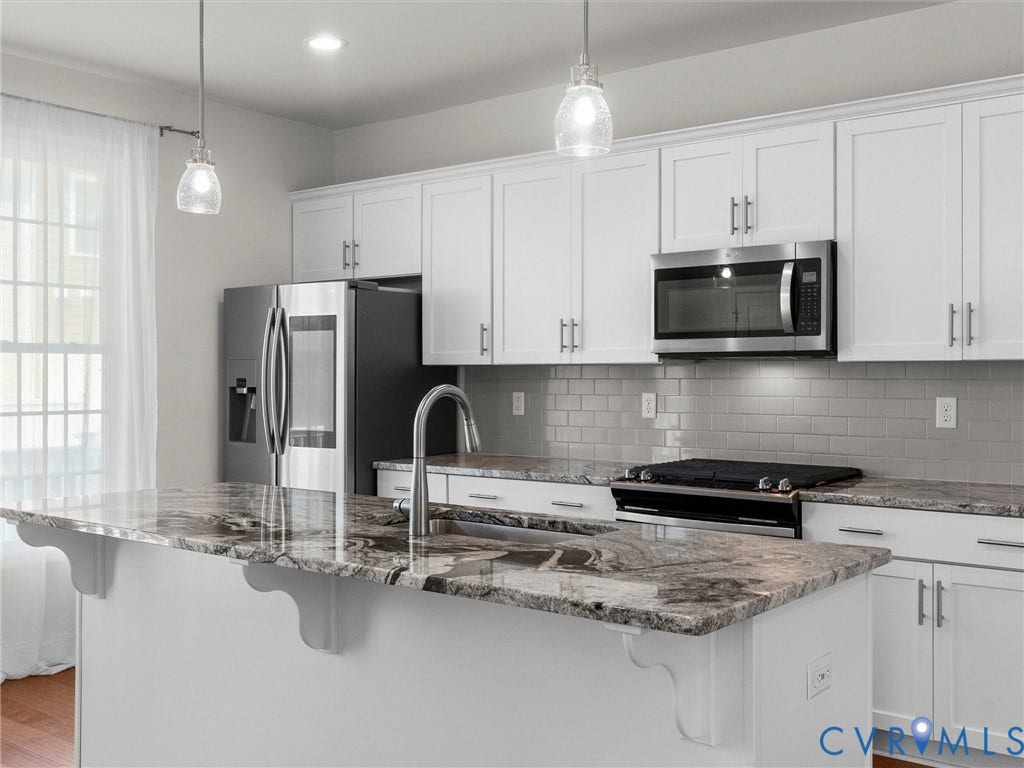 14227 Michaux Village Drive, Winterfield Park, Midlothian, VA 23113 White shaker cabinetry, stainless steel appliances, granite countertops, subway tile backsplash, and pendant lighting