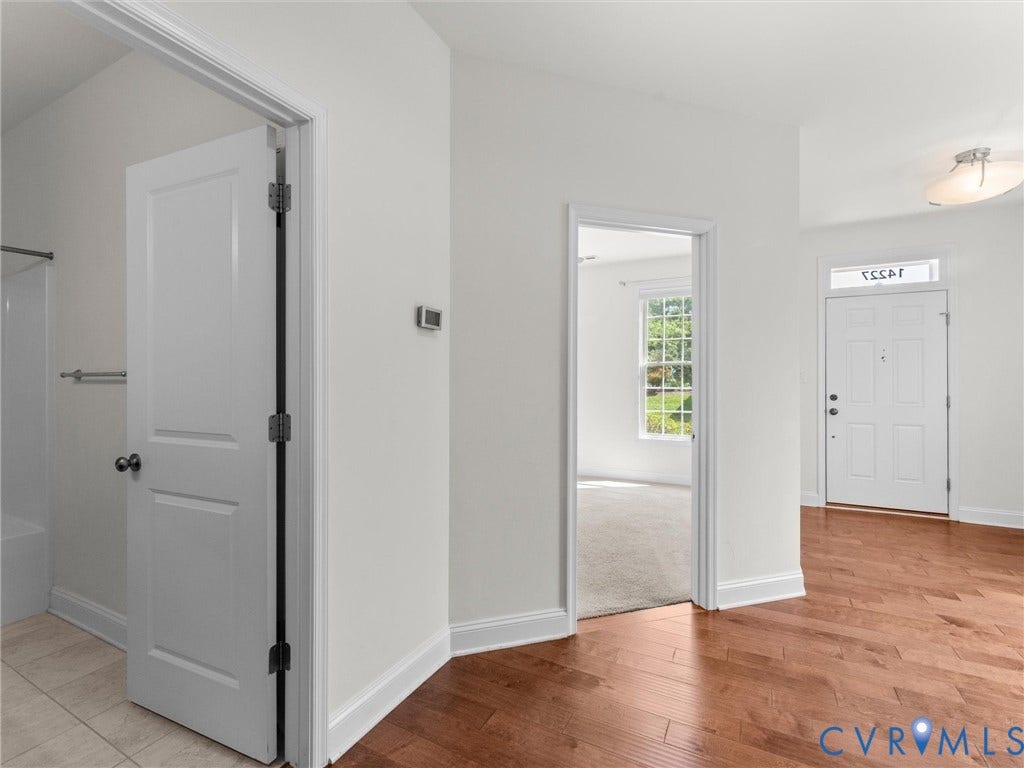 14227 Michaux Village Drive, Winterfield Park, Midlothian, VA 23113 Wood-finish flooring, white panel doors, recessed wall thermostat, front door with transom window, and ceiling-mounted light fixture