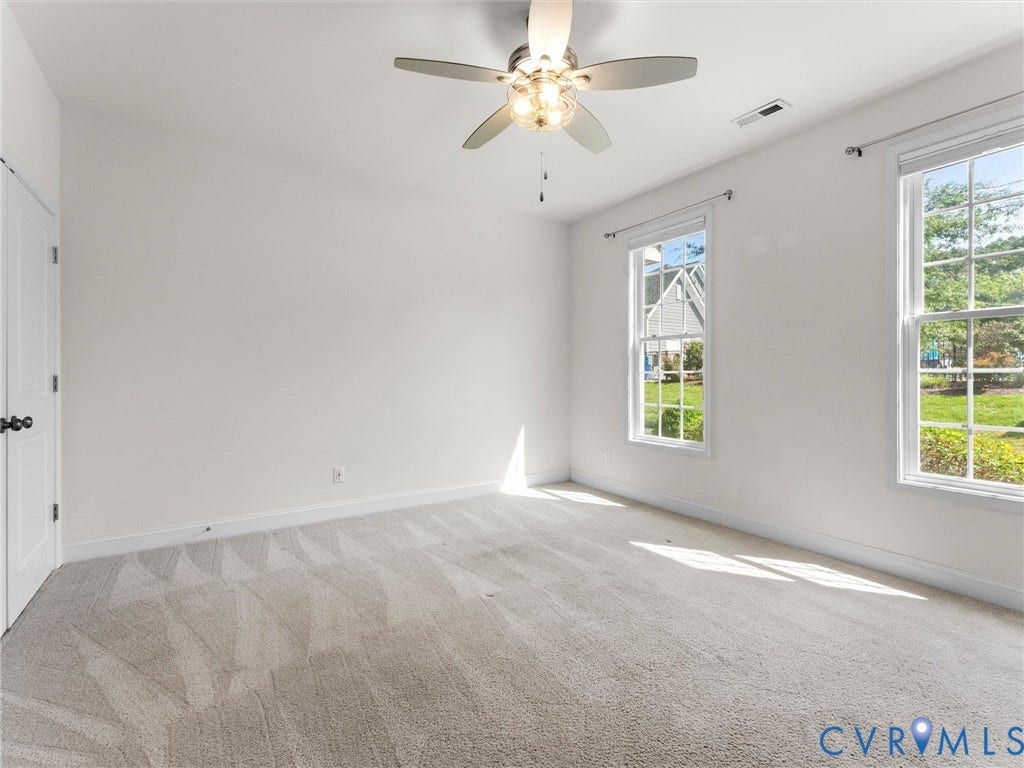 14227 Michaux Village Drive, Winterfield Park, Midlothian, VA 23113 Two large windows, ceiling fan with integrated lighting, neutral carpeting, white interior door, and light-toned walls