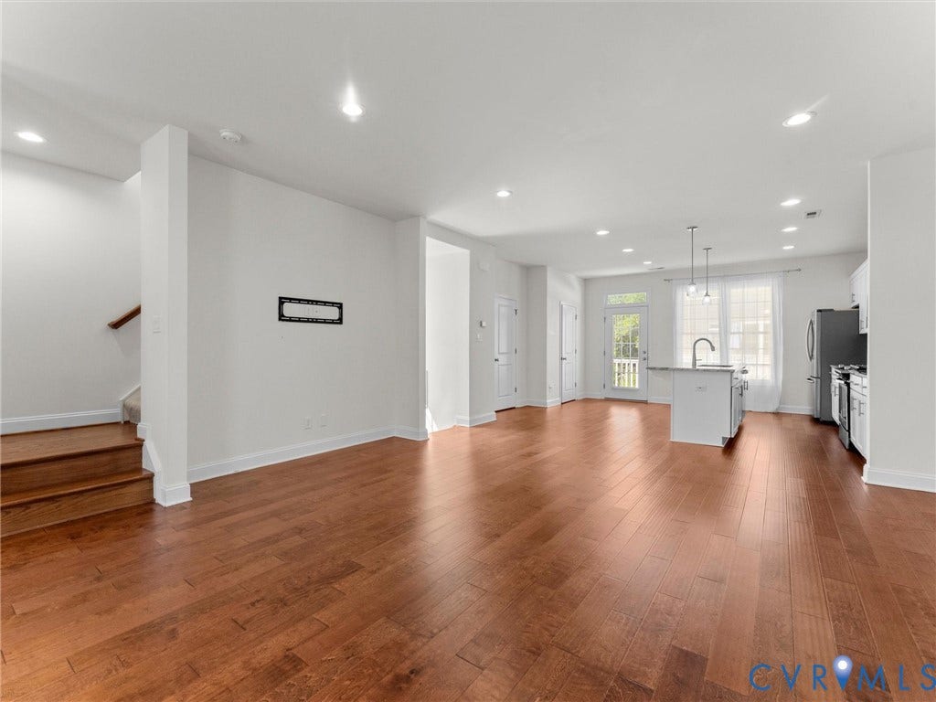 14227 Michaux Village Drive, Winterfield Park, Midlothian, VA 23113 Open-concept living space featuring wood-finish flooring, recessed lighting, and a kitchen island with pendant lighting