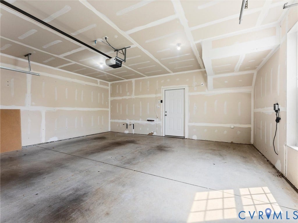 14227 Michaux Village Drive, Winterfield Park, Midlothian, VA 23113 Spacious garage featuring concrete flooring, a single entry door, and an overhead garage door opener system