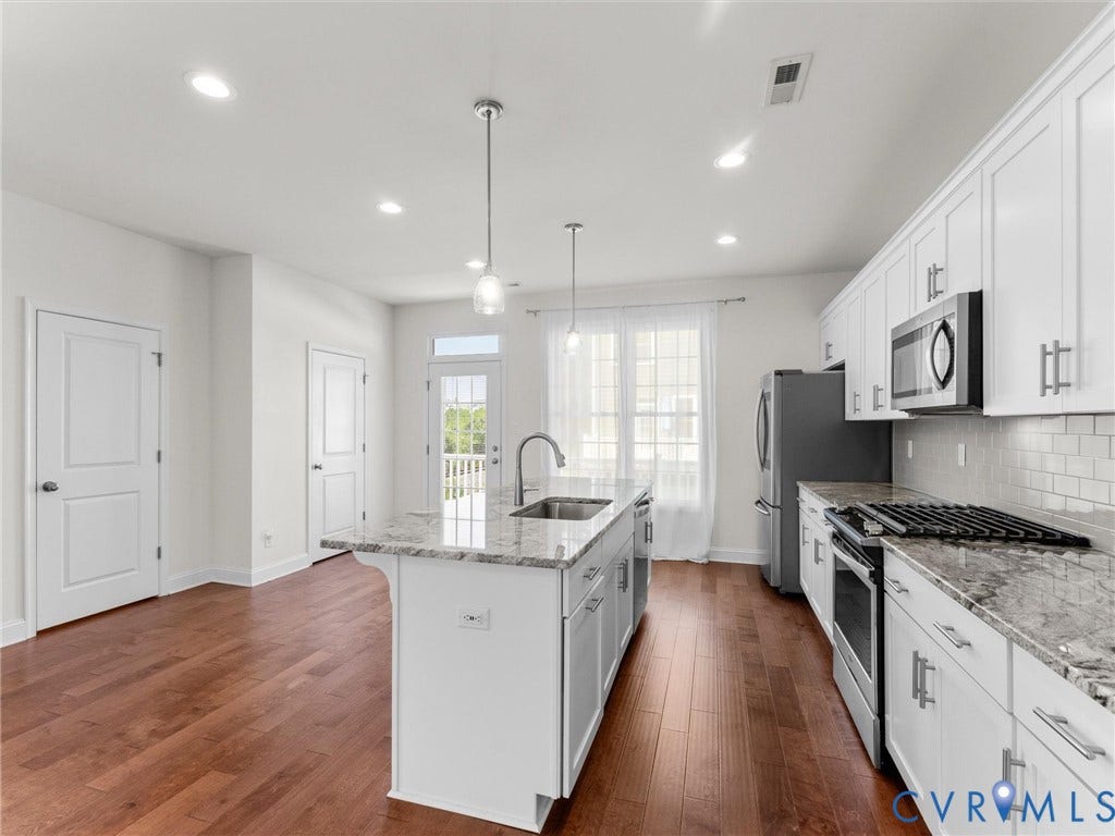 14227 Michaux Village Drive, Winterfield Park, Midlothian, VA 23113 Kitchen featuring wood-finish flooring, white cabinetry, a kitchen island with sink, stainless steel appliances, and recessed lighting