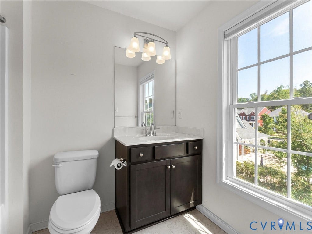 14227 Michaux Village Drive, Winterfield Park, Midlothian, VA 23113 Single vanity with a light countertop, dark wood-finish cabinetry, and a framed mirror