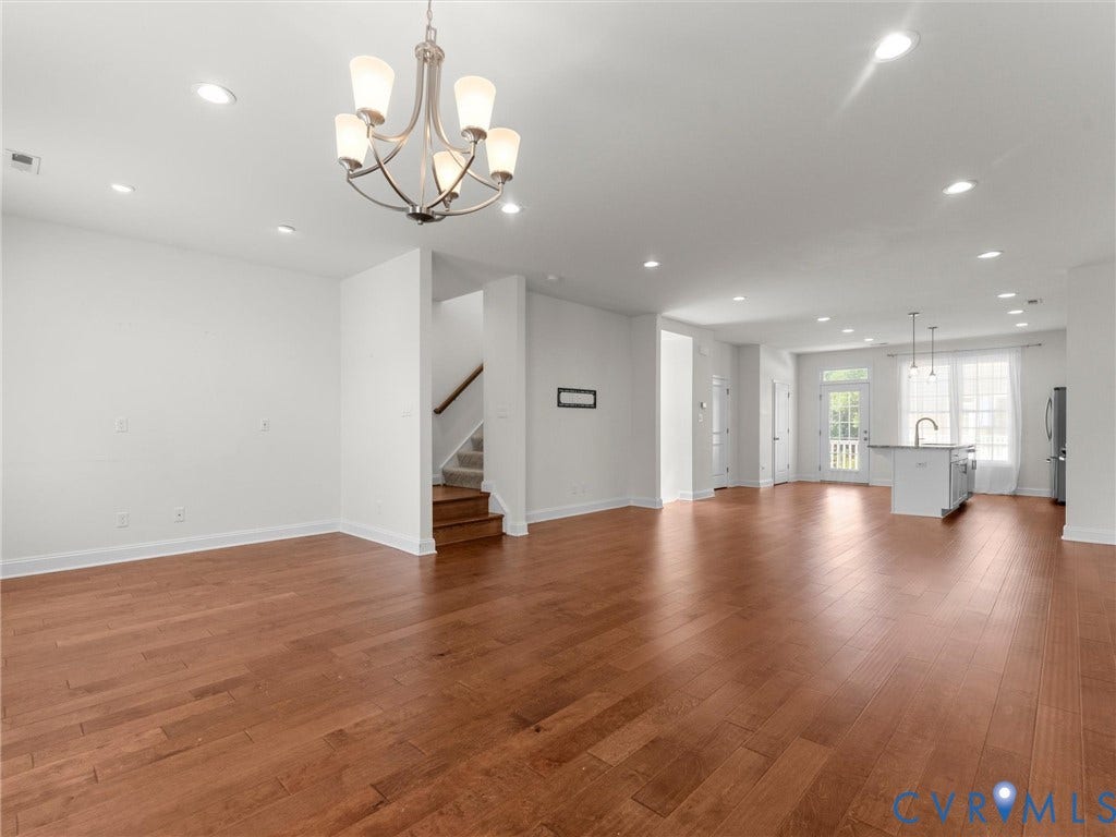 14227 Michaux Village Drive, Winterfield Park, Midlothian, VA 23113 Expansive open-concept layout with wood-finish flooring, a contemporary chandelier, recessed lighting, and a kitchen island with pendant lighting