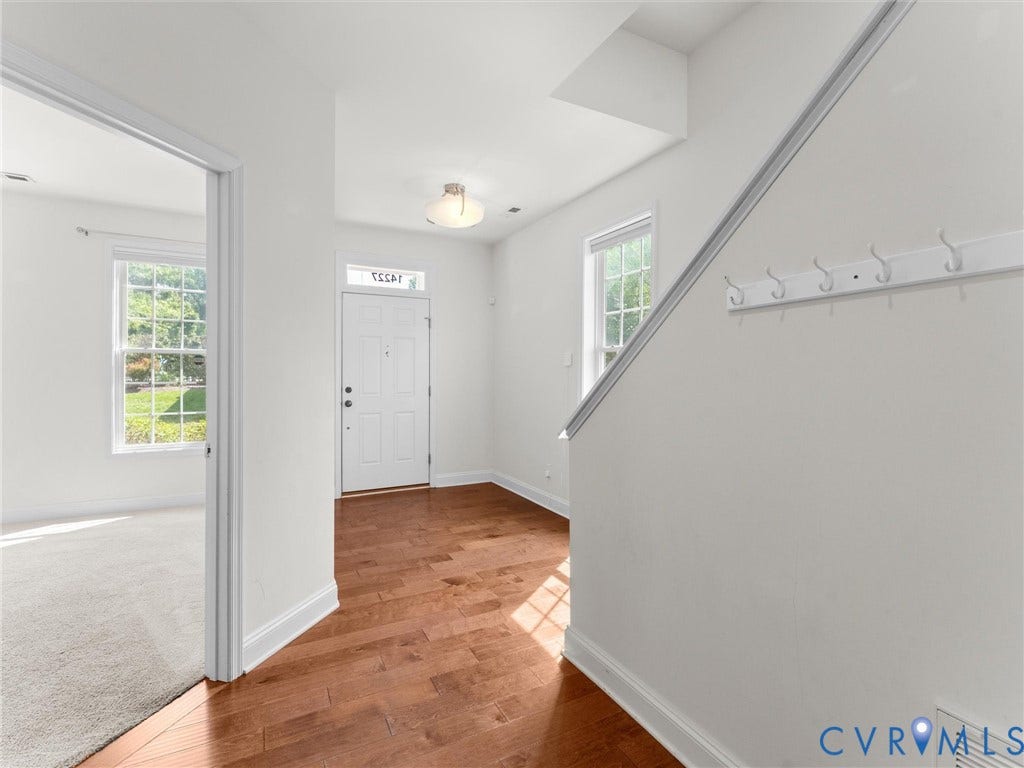 14227 Michaux Village Drive, Winterfield Park, Midlothian, VA 23113 White front entry door with transom window, wood-finish flooring, and a flush mount ceiling light fixture
