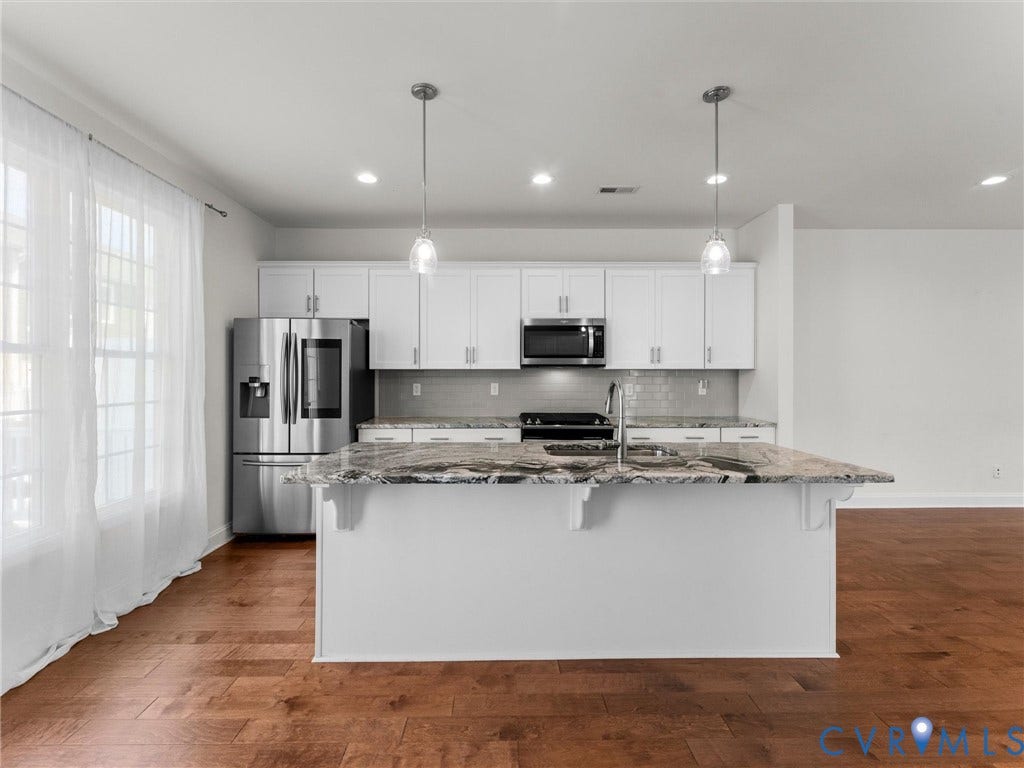 14227 Michaux Village Drive, Winterfield Park, Midlothian, VA 23113 Kitchen featuring a large island with stone countertops, stainless steel appliances, white cabinetry, and wood-finish flooring
