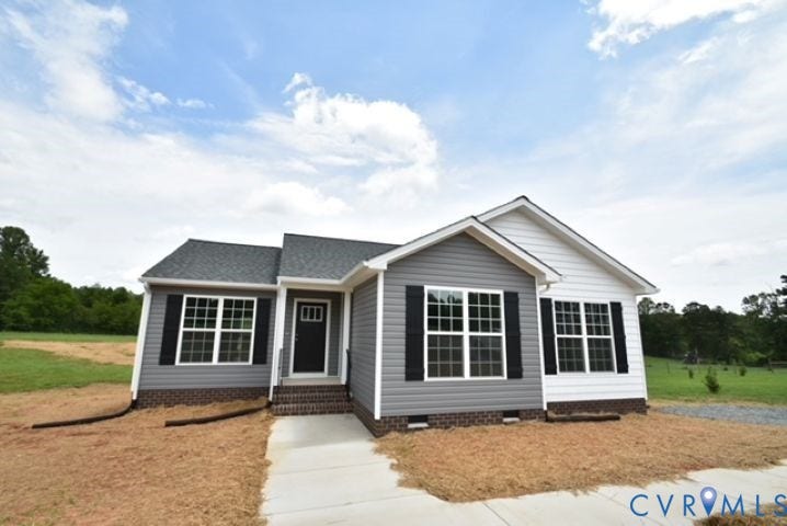 410 Kents Mill Rd, Louisa, VA 23093 Siding exterior with brick foundation, dark shingle roof, and multiple windows with black shutters