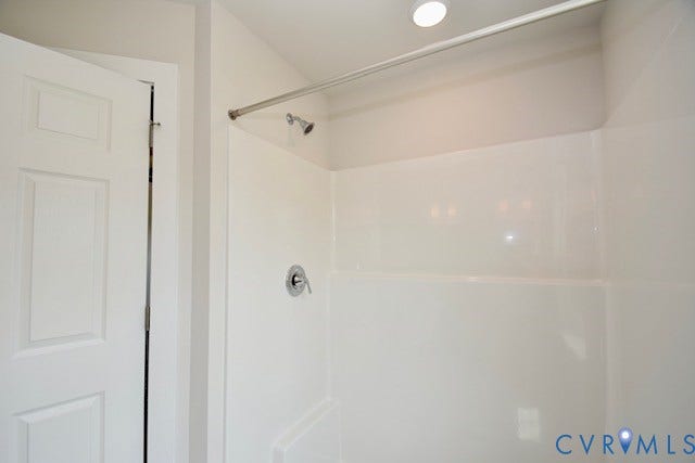 410 Kents Mill Rd, Louisa, VA 23093 White shower enclosure with a chrome showerhead and control