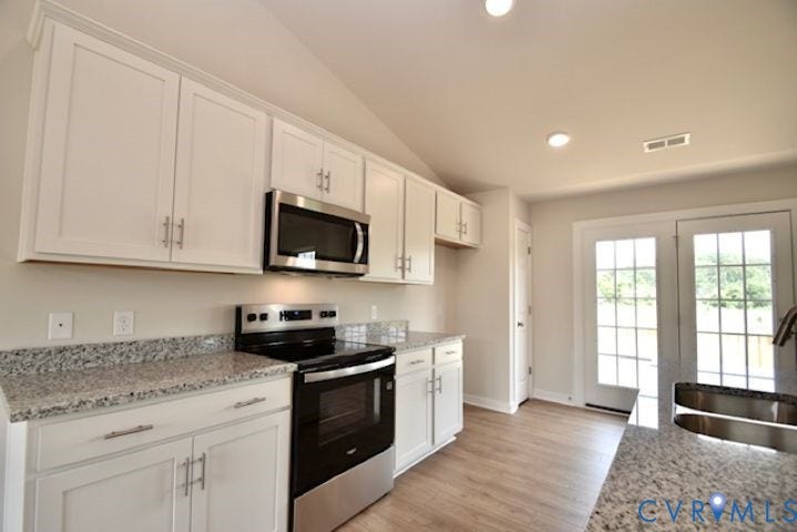 410 Kents Mill Rd, Louisa, VA 23093 Kitchen featuring white shaker cabinetry, granite countertops, stainless steel appliances, wood-finish flooring, and French doors
