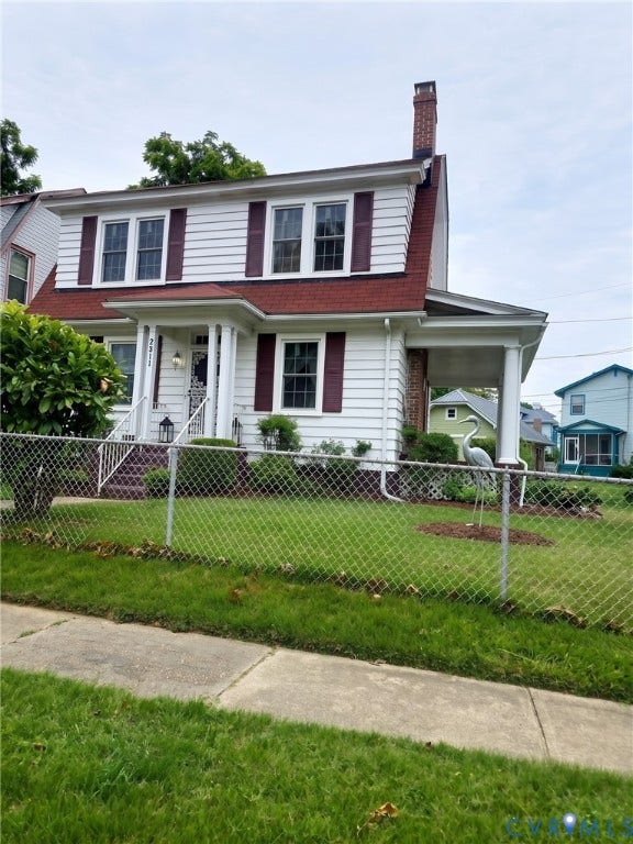 2811 Woodcliff Avenue, Richmond, VA 23222 White siding exterior with a red roof, front porch with columns, upper-level dormer windows, and a brick chimney