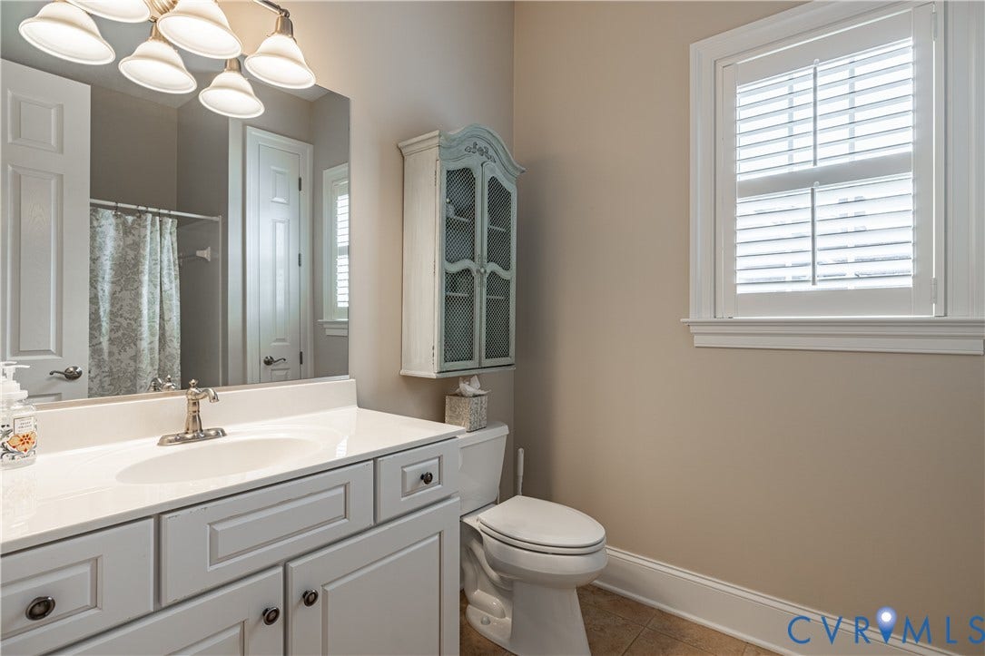 12917 Holmbank Lane, Henrico, VA 23233 Vanity with integrated sink, large mirror, and window with plantation shutters