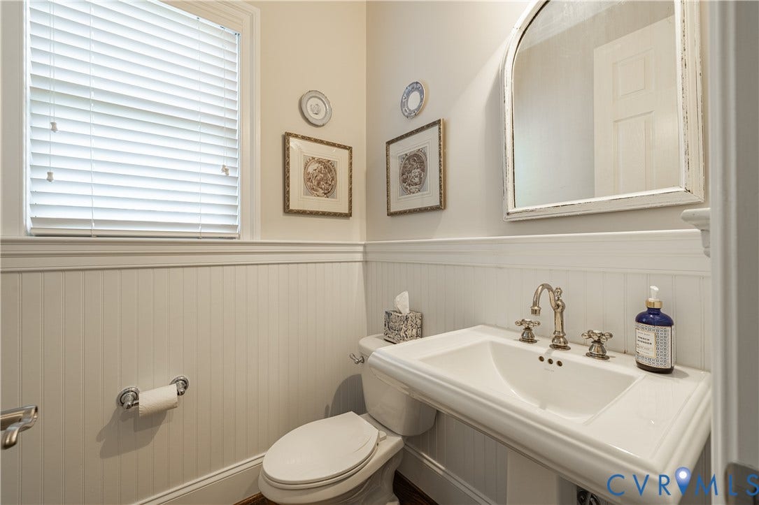 12917 Holmbank Lane, Henrico, VA 23233 Pedestal sink, beadboard wainscoting, and a decorative framed mirror