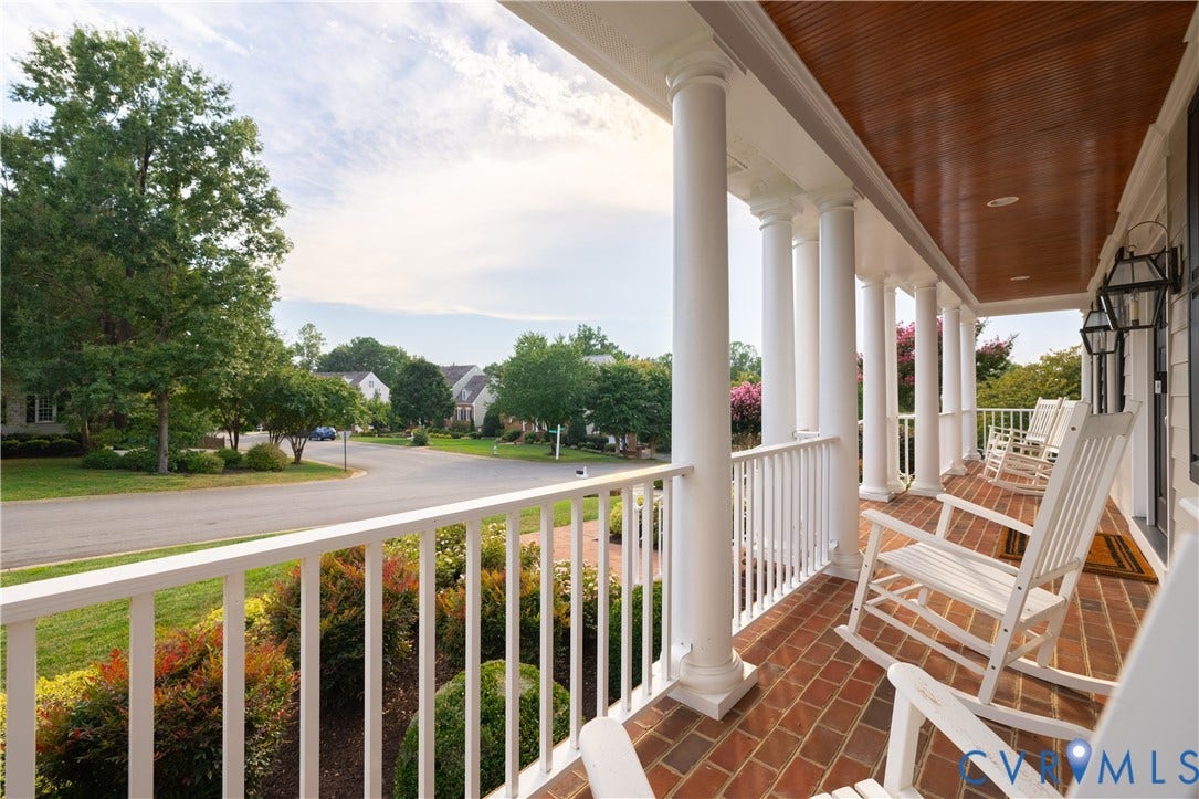 12917 Holmbank Lane, Henrico, VA 23233 Expansive front porch featuring brick flooring, white columns, wood-finish ceiling, and exterior wall lanterns