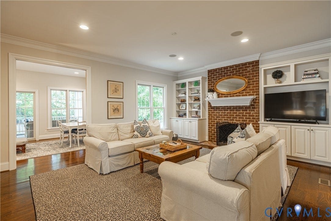12917 Holmbank Lane, Henrico, VA 23233 Built-in cabinetry, exposed brick fireplace, recessed lighting, crown molding, and hardwood flooring
