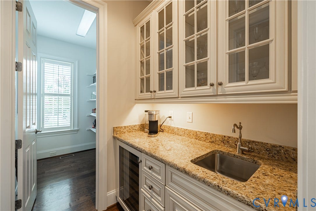 12917 Holmbank Lane, Henrico, VA 23233 Built-in cabinetry with glass-front uppers, stone countertops, integrated sink with faucet, and a wine cooler