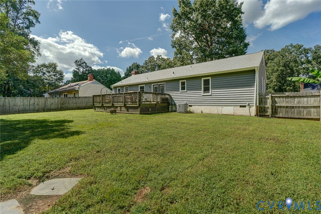 4647 Brookridge Road, Chesterfield, VA 23832 Expansive backyard featuring a spacious wood deck, gray horizontal siding, and a privacy fence