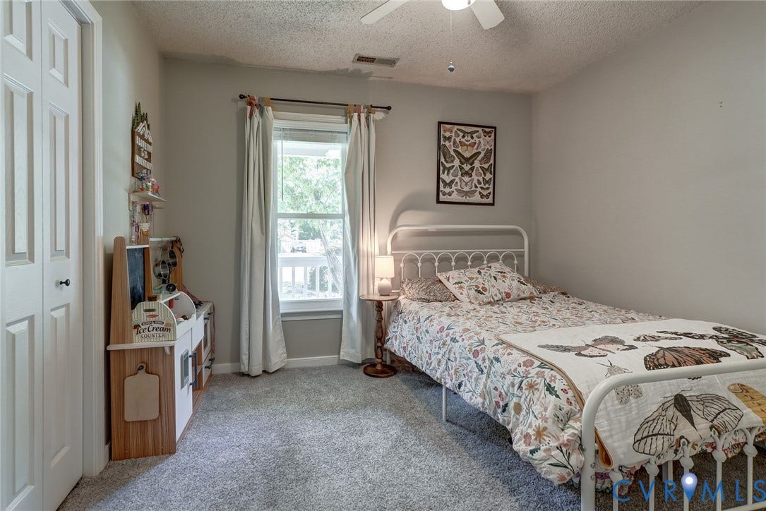 4647 Brookridge Road, Chesterfield, VA 23832 Soft gray wall paint with textured ceiling, white bi-fold closet doors, and white window trim