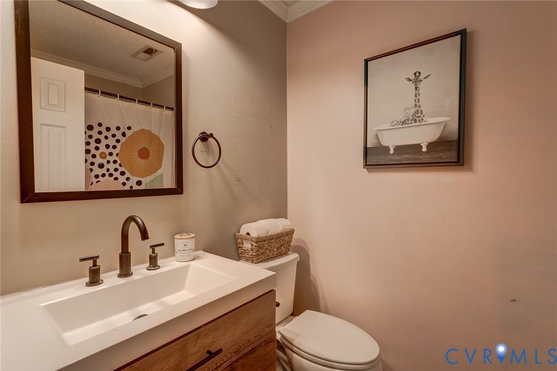 4647 Brookridge Road, Chesterfield, VA 23832 Wood-finish vanity with an integrated rectangular basin and dark bronze-finish fixtures