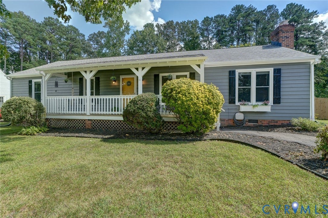 4647 Brookridge Road, Chesterfield, VA 23832 Gray siding exterior with white trim, covered front porch, white porch railing, and a brick chimney