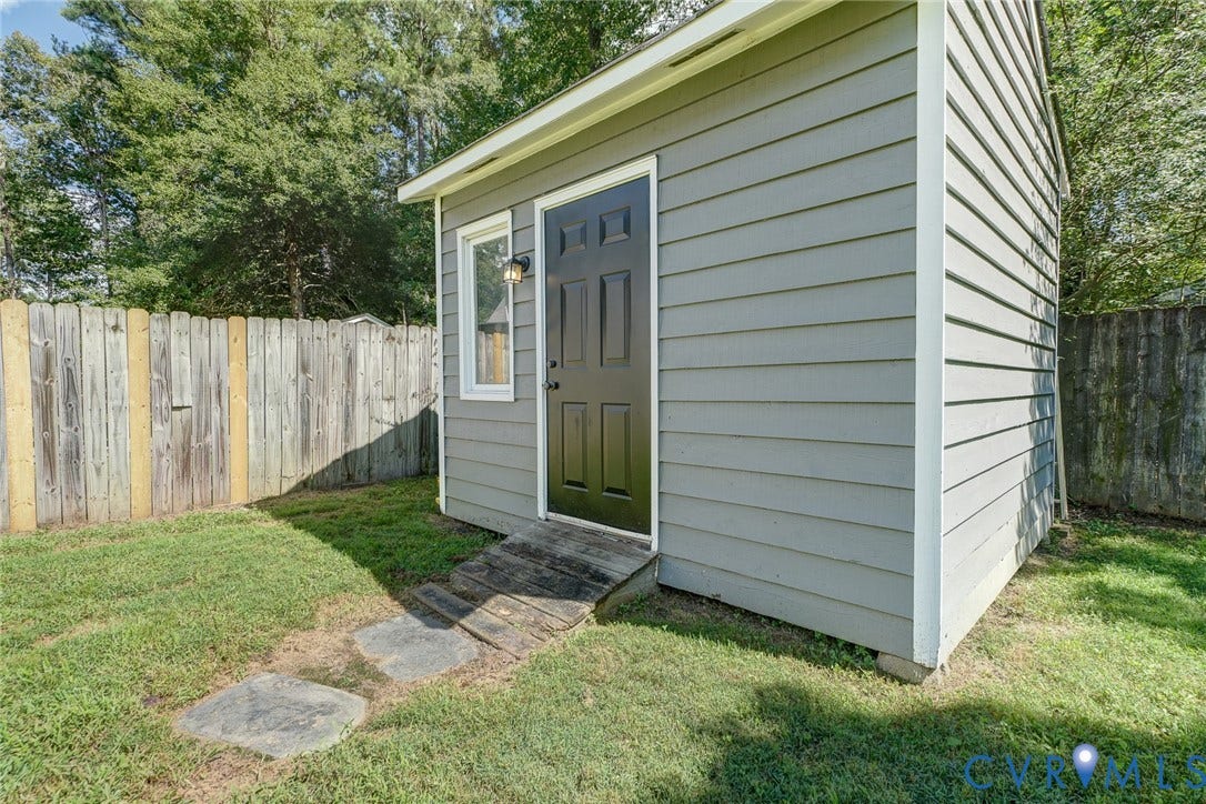 4647 Brookridge Road, Chesterfield, VA 23832 Detached auxiliary structure with horizontal siding, a paneled door, exterior lighting, a single window, and a wood ramp entry