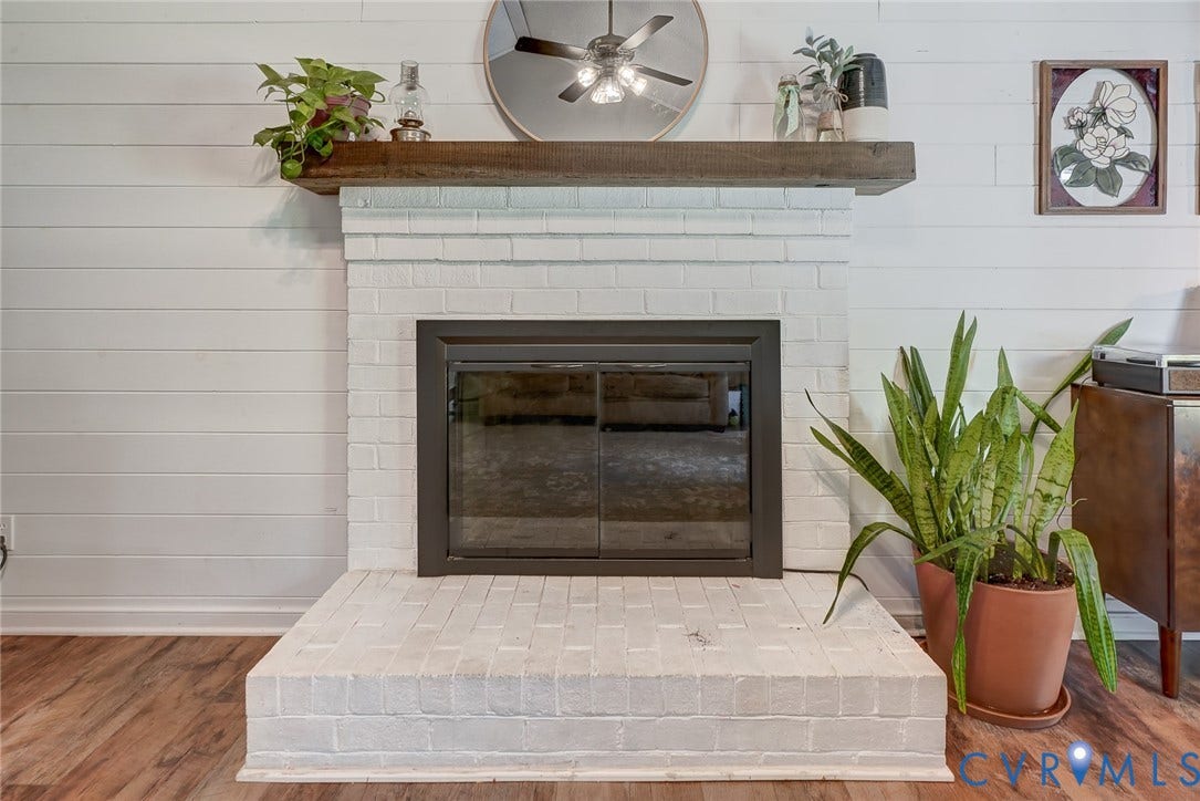 4647 Brookridge Road, Chesterfield, VA 23832 White-painted brick fireplace with a dark metal firebox and a substantial wood mantel