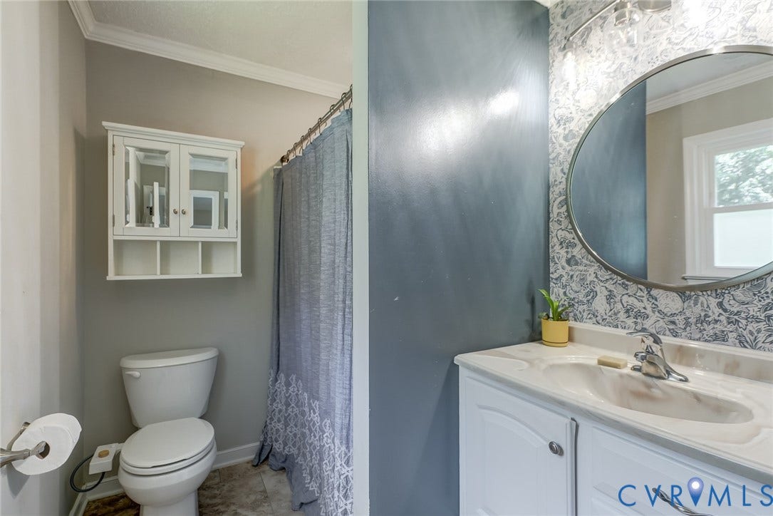4647 Brookridge Road, Chesterfield, VA 23832 Bathroom featuring a vanity with an integrated sink, round mirror, and a wall-mounted medicine cabinet