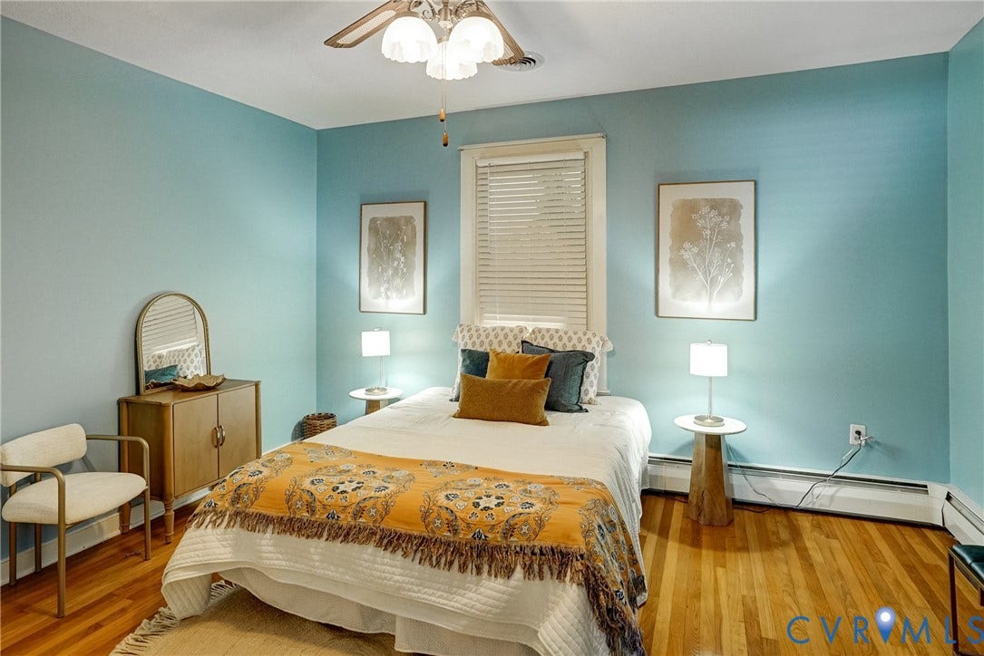 Hardwood flooring, painted walls, ceiling fan with light fixture, and window with blinds